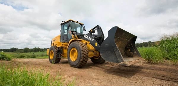 Wheel Loader driving along dirt road