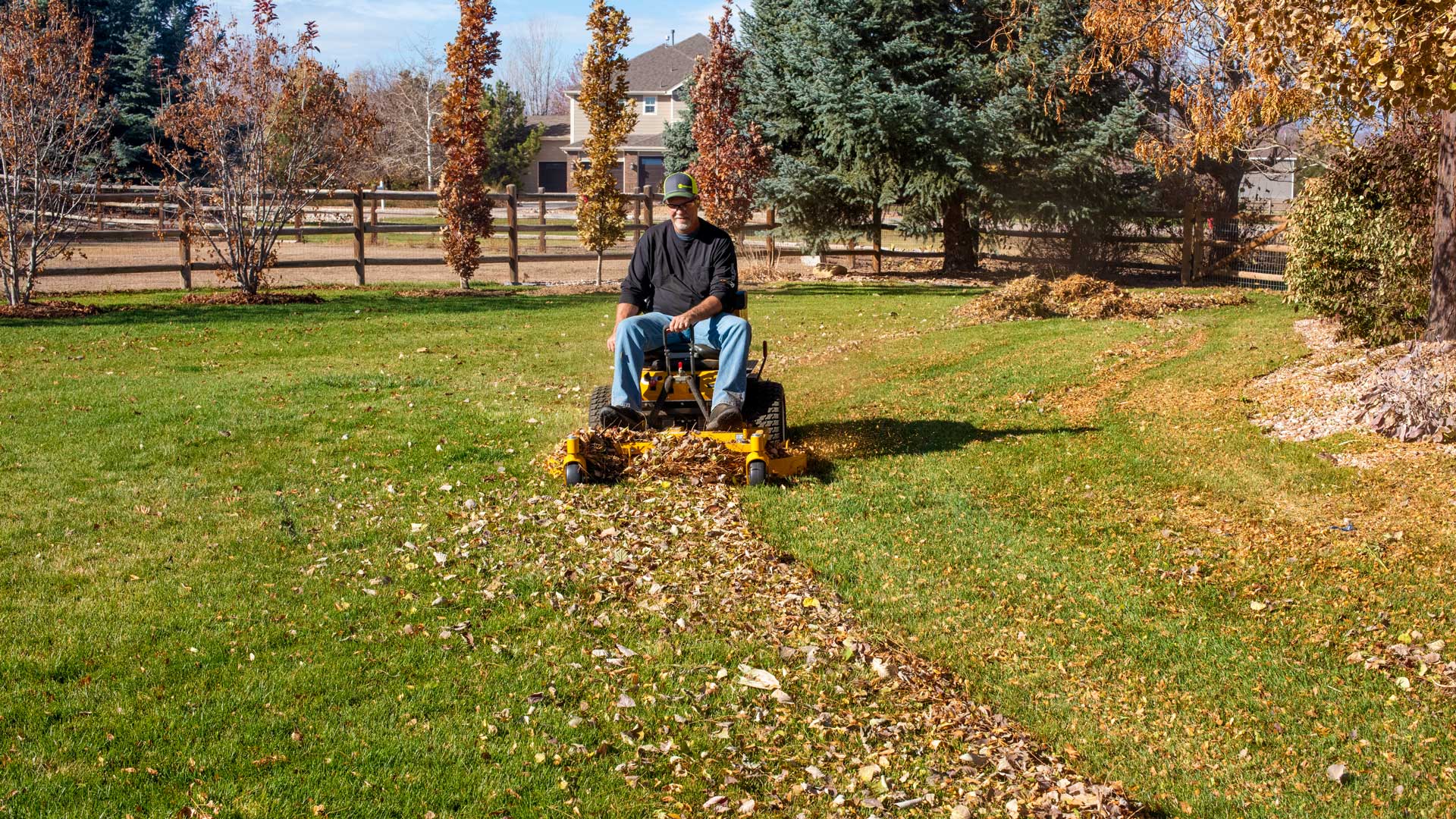 Image of a Walker B27i Mower with an M48 Mulching Deck Mulching Fall Leaves