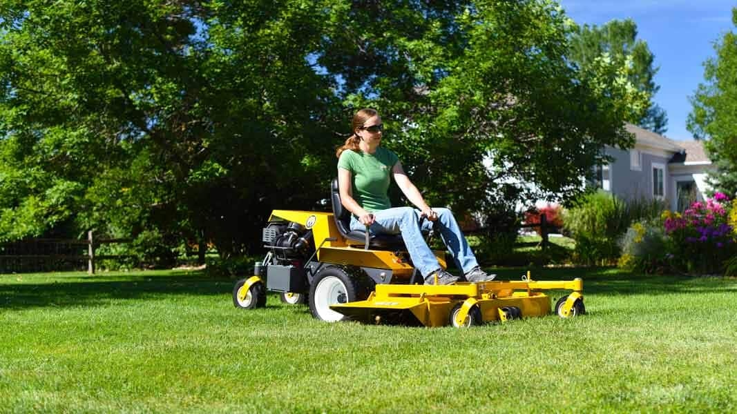 Woman mowing a lawn on a Walker Model B lawn mower